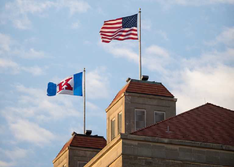 U.S. and KU flags flying above Fraser Hall