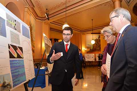 "Doctoral student Gregory Leung explains his research on the impact of medical marijuana on mental health of college students to Chancellor Girod and Provost and Executive Vice Chancellor Barbara A. Bichelmeyer during the 2020 Capitol Graduate Research Summit."