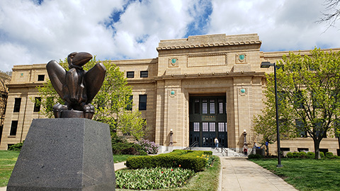 Strong Hall in and the Jayhawk statue in spring.